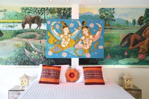 a bedroom with a bed with a painting on the wall at The Orchid Resort & Relax in Maha Sarakham +77 photos