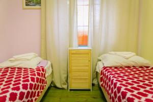 1 dormitorio con 2 camas y ventana en Fusion Hostel, en Moscú