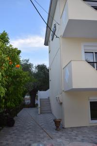 a white building with a staircase next to a building at Tsafas Αpartments in Limenas