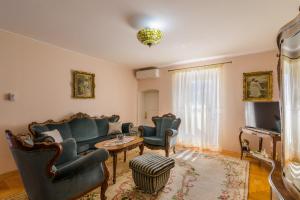 a living room with a couch and chairs and a table at Villa Andante in Trogir