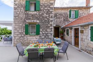 a patio with a table and chairs and a building at Villa Andante in Trogir