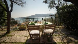 a table with two chairs sitting next to a fence at Apartment Portovenere in Portovenere