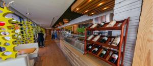 a store aisle with bottles of wine on display at Xanadu Resort in Sianozety
