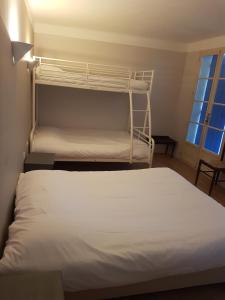 a bedroom with two bunk beds and a window at Abri Du Ventoux in Malaucène