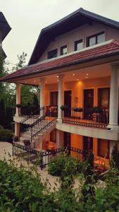 a house with a balcony with tables and chairs at ŽUPAN apartmani in Soko Banja