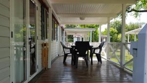 a porch with chairs and a table on it at Mobilhome Angel in Cavallino-Treporti