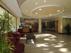 a lobby with chairs and a table in a building at Hotel Astoria Park in Lloret de Mar