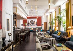 a lobby with couches and chairs and a bar at Hotel Vilòn - Small Luxury Hotels of the World in Rome