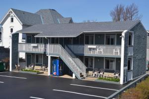 a building with a parking lot in front of it at The Ship Motel in Alexandria Bay