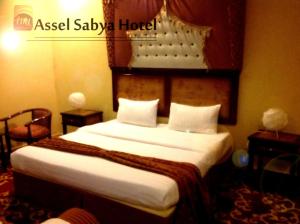 Gulta vai gultas numurā naktsmītnē Aseel Hotel Apartment