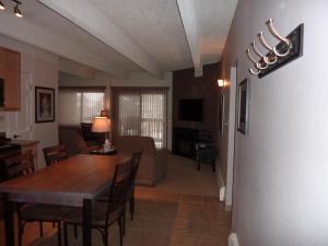 a dining room and living room with a table and chairs at Heart of Frisco Condo in Frisco