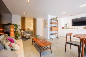 a living room with a couch and a table at 1bd apartment with garden Brugmann area in Brussels