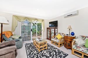 a living room with a couch and chairs at 354 Owen Street Port Macquarie in Port Macquarie