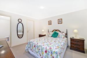 a bedroom with a bed and a dresser and a mirror at 354 Owen Street Port Macquarie in Port Macquarie