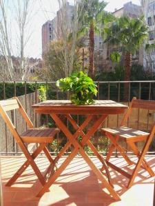 バルセロナにあるLovely double apartment - Sagrada Familiaの木製テーブル(椅子2脚付)と鉢植え