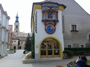 a building with a clock on the side of it at Veronika Apartment in Székesfehérvár