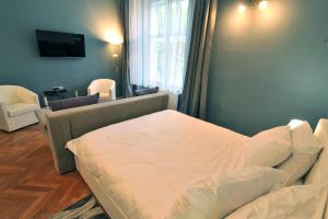a living room with a bed and a couch at Apartment 9 - City centre in Sibiu
