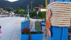 a large coil of rope on the side of a building at Studios-Heaven in Chrysi Ammoudia