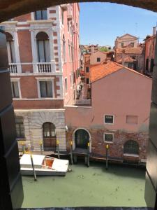 a view of a canal in a city with buildings at Penthouse Of Venice in Venice