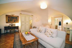 ein Wohnzimmer mit einem weißen Sofa und einem Tisch in der Unterkunft Baroque in Zagreb