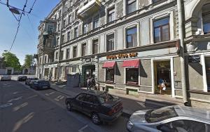 a city street with cars parked in front of buildings at Polikoff in Saint Petersburg