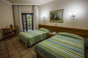 A bed or beds in a room at Catussaba Resort Hotel