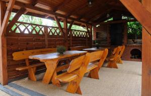 a large wooden table and benches in a pavilion at Willa Krystal in Ciechocinek