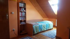 a bedroom with a bed and a book shelf at Apartman Glomazic in Žabljak