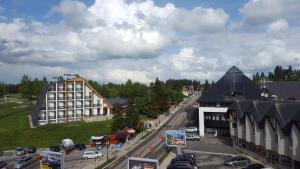 arial view of a city with a hotel and a parking lot at Apartman Glomazic in Žabljak