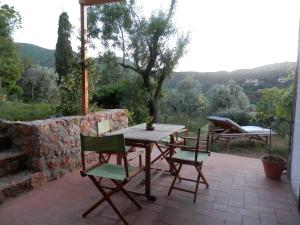 a wooden table and chairs on a patio at Dèpendance Argentario in Porto Santo Stefano