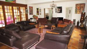 a living room with leather couches and a table at Domaine Zen Art'Titude - EVG Fêtes acceptées in Renneville