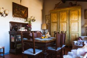 a dining room with a table and chairs and a room with aventory at B&B La Zolla in Impruneta