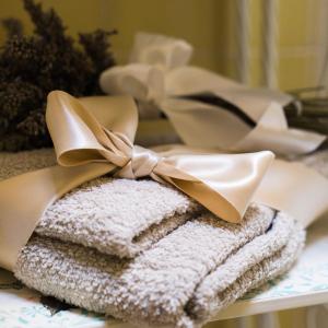 a pile of towels with a bow on a table at B&B La Zolla in Impruneta