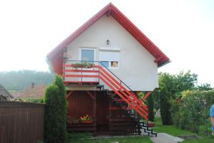 a house with a red and white trim at Pensiunea Ivanciu Bogdan in Praid