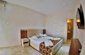 Postel nebo postele na pokoji v ubytování Jijo's Hotel