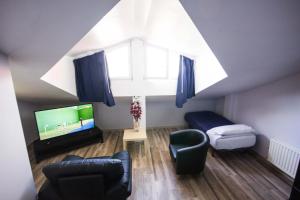 a living room with a large window and a tv at Hotel Ria de Bilbao in Bilbao