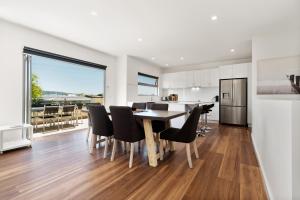 a kitchen and dining room with a table and chairs at Rosewater Townhouses Dromana in Dromana