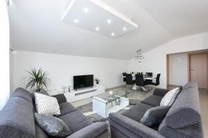 a living room with a couch and a television at Apartment Monika - Private terrace & Parking in Zadar