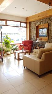 a living room with a couch and a table at Hotel Tierra del Fuego in Ushuaia