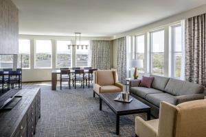 a living room with a couch and a table at Hotel Madison & Shenandoah Conference Ctr. in Harrisonburg