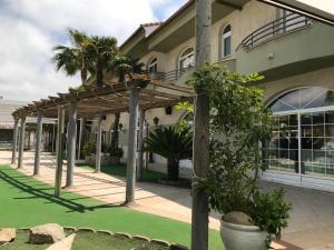 a pergola in front of a building at Hospedium Hotel Twist in Torredonjimeno