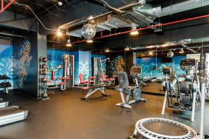 a gym with several treadmills and machines in it at Park Inn San Jose by Radisson in San José