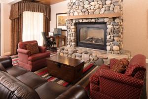 a living room with couches and a stone fireplace at Red Lion Hotel Twin Falls in Twin Falls