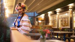 a woman standing at a table in a restaurant at Hotel Finca Lerida Coffee Plantation and Boutique Hotel in Boquete