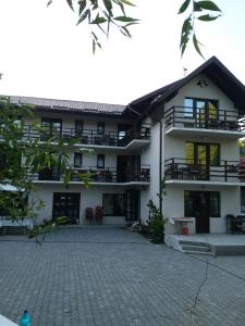 a building with a courtyard in front of it at Casa Tican in Bran
