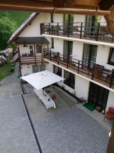 an overhead view of a building with a white umbrella at Casa Tican in Bran +25 photos