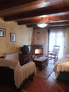 - un salon avec un canapé et une cheminée dans l'établissement Casa Gómez, à Mosqueruela