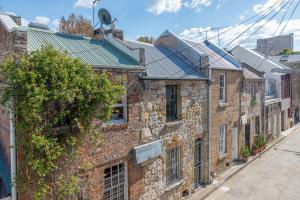 an old brick building with windows and a street at Chic East Sydney Pad in Sydney