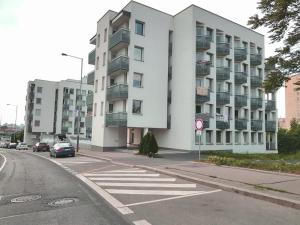 a white apartment building on the side of a street at G support apartment in Prague