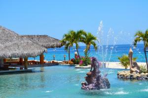 a fountain in the water in front of a resort at Hotel Palmas De Cortez in Los Barriles